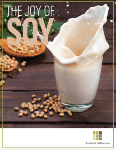 Soy milk splashing into a glass next to soybeans with the text The Joy of Soy
